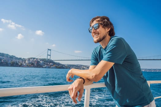 Happy man enjoying the sea from ferry boat crossing Bosphorus in Istanbul. Summer trip to Istanbul.