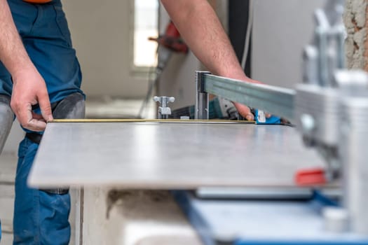 manual cutting of facing tiles on a cutter. High quality photo
