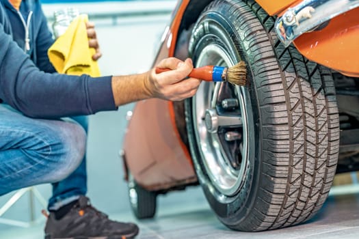 manual cleaning of car tires with a brush. High quality photo