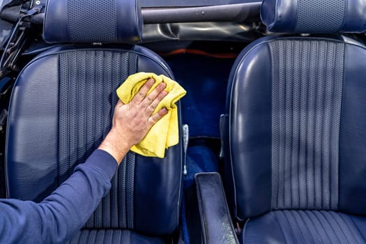 manual cleaning of the leather in the interior of the car with a micro towel.