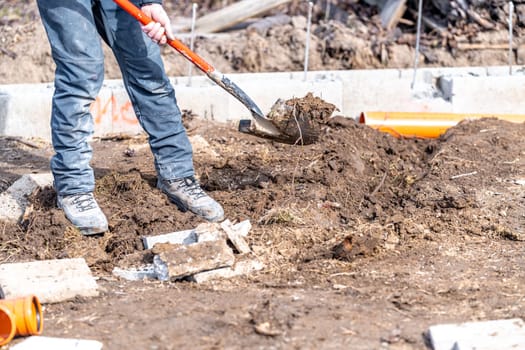 excavated from the ground with a shovel for a sewerage fund made of PVC pipes. High quality photo
