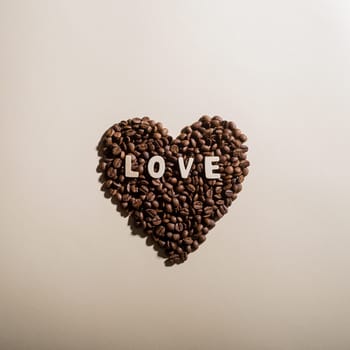 Close-up of coffee beans in the shape of a heart and the inscription love.