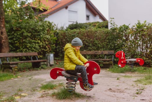 Funny cute happy baby playing on the playground. The emotion of happiness, fun, joy. Smile of a child. boy playing on the playground.