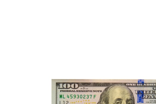 Close up detail of part of modern USD hundred dollar bill showing blue anti-counterfeit band, part of Franklin's face, isolated on white background. Copy space. High quality photo