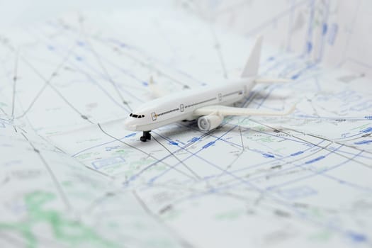 Miniature model airplane on a flight sectional map with focus on the foreground, background blur. High quality photo