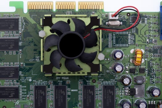 Close up of a graphics card, circuit board with cooling fan, circuits, wiring. High quality photo