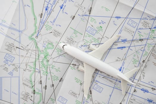 Close up of a miniature airplane on an FAA aviation sectional navigation map showing Oakland airport approach. High quality photo