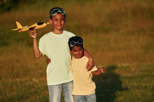 At summer daytime together. Two african american kids have fun in the field.