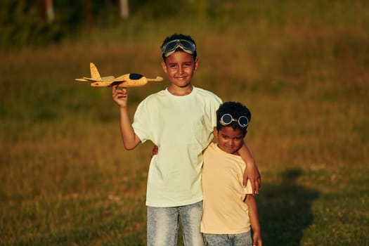 At summer daytime together. Two african american kids have fun in the field.