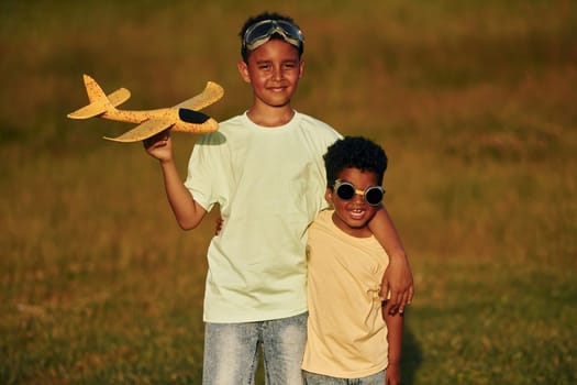 At summer daytime together. Two african american kids have fun in the field.