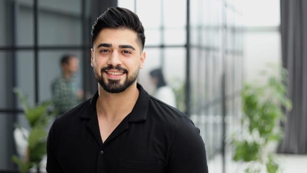 Young handsome businessman in a black shirt.