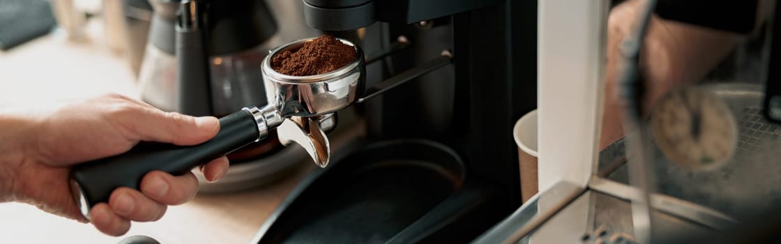 Process of pouring ground coffee into the filter from the coffee grinder