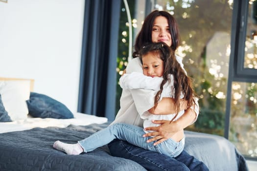 Love of child and parent. Mother and her daughter spending time together at home.