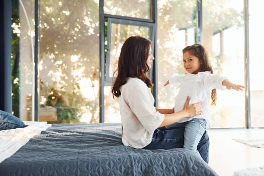 Love of child and parent. Mother and her daughter spending time together at home.