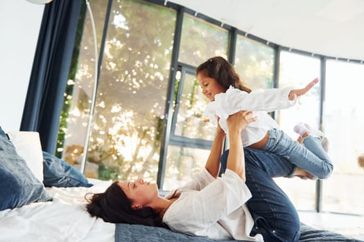 Playing together. Mother and her daughter spending time at home.