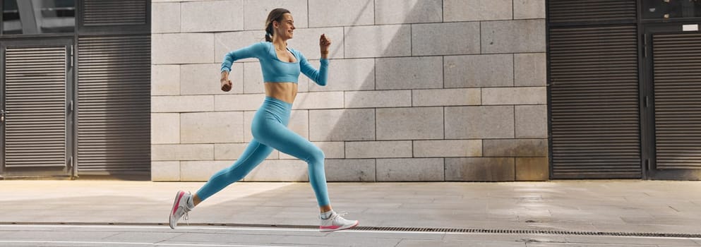 Beautiful fit young woman jogger is running outdoors