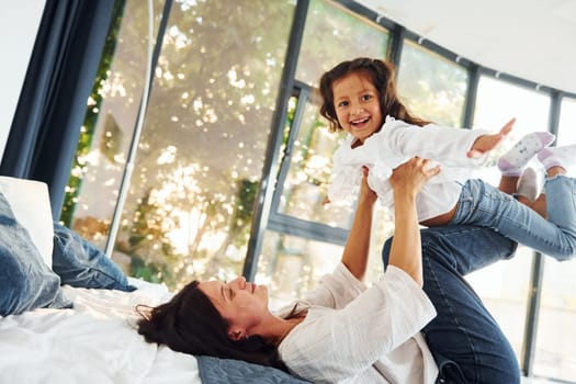 Playing together. Mother and her daughter spending time at home.