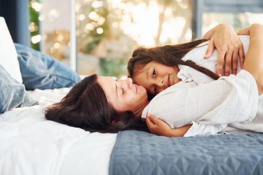 Playing together. Mother and her daughter spending time at home.