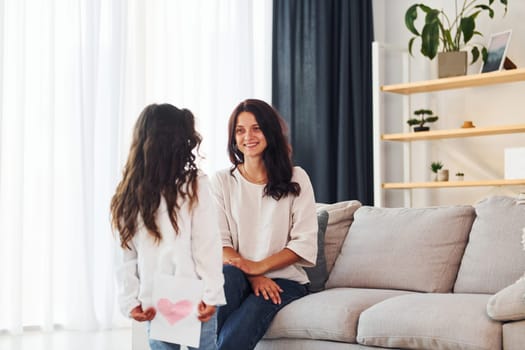 Happy mother's day. Woman and her daughter spending time together at home.