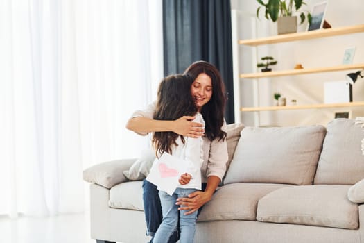 Happy mother's day. Woman and her daughter spending time together at home.