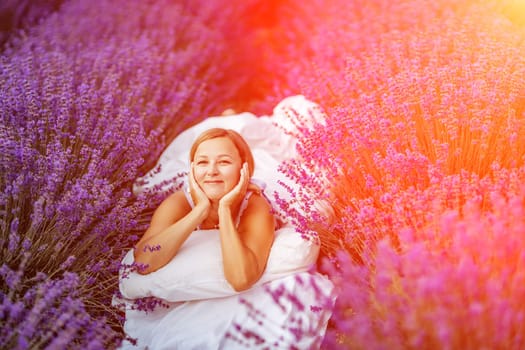 A middle-aged woman lies in a lavender field and enjoys aromatherapy. Aromatherapy concept, lavender oil, photo session in lavender.