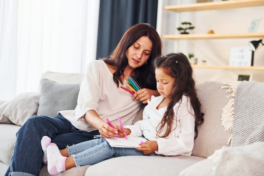 Modern design. Mother and her daughter spending time together at home.