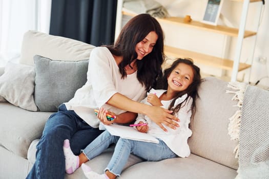 Modern design. Mother and her daughter spending time together at home.