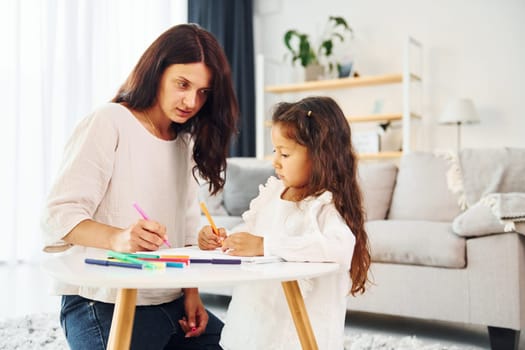 Happy family. Mother and her daughter spending time together at home.