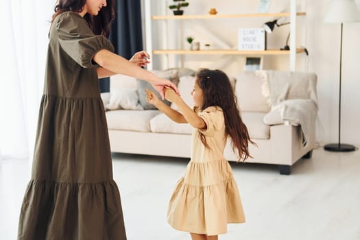 Happy family. Mother and her daughter spending time together at home.