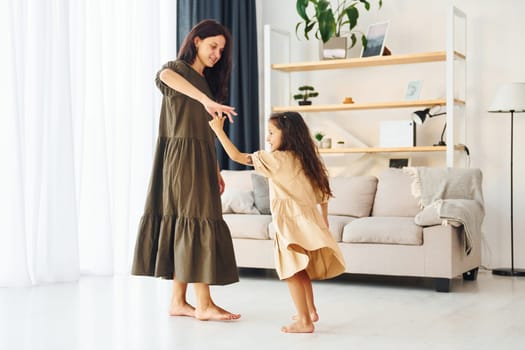 Happy family. Mother and her daughter spending time together at home.