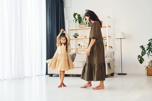 Happy family. Mother and her daughter spending time together at home.