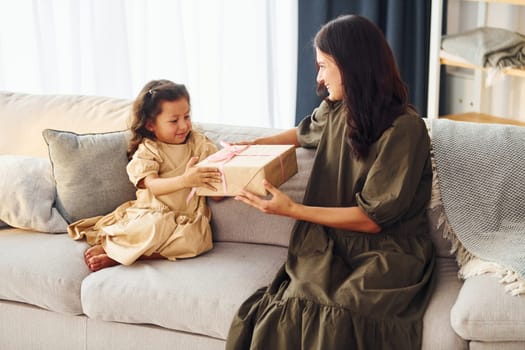 Conception of parent love. Mother and her daughter spending time together at home.