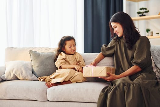 Conception of parent love. Mother and her daughter spending time together at home.