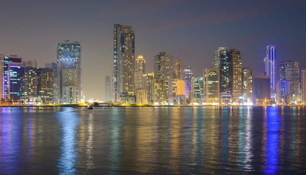 Night landscape of the embankment of the emirate of Sharjah, United Arab Emirates