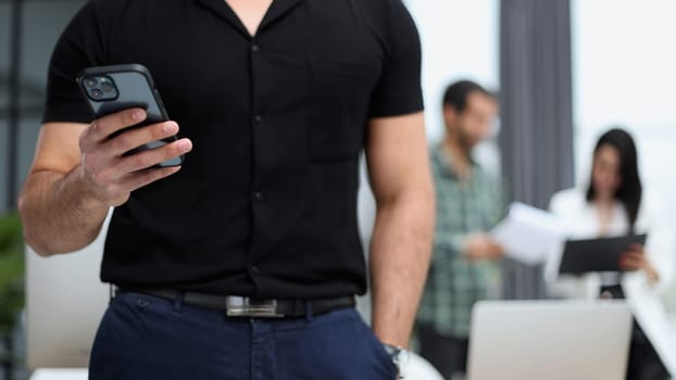 Modern gadget. Close-up of a smartphone screen in the hands of a businessman.