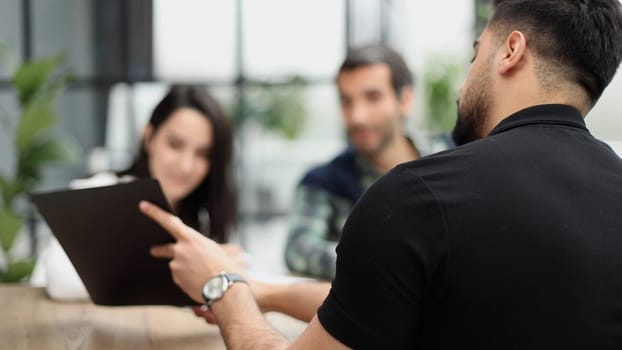 shirt shows a report to colleagues at work in the office
