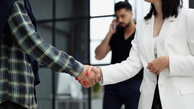manager shaking hands with satisfied male client after successful business meeting during break