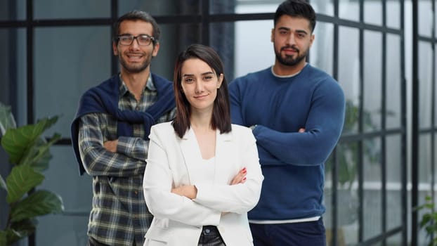 three colleagues stand in the lobby of a modern office