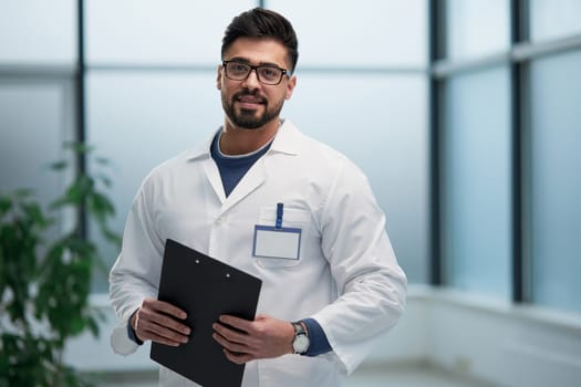 experienced doctor with a folder in his hands in the hospital