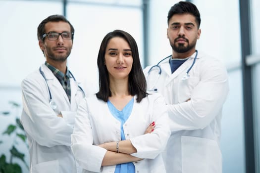 Portrait of three confident doctors in the hospital corridor