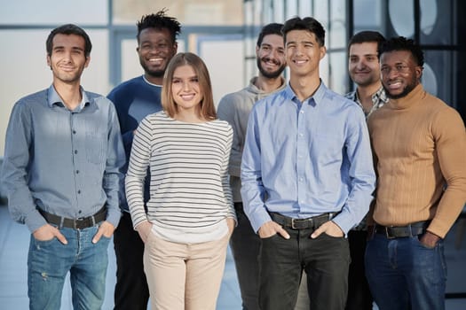 Everybody brings a different skill to the team. Portrait of a diverse group of coworkers standing in an office.