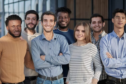 Everybody brings a different skill to the team. Portrait of a diverse group of coworkers standing in an office.
