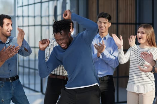 happy multiracial colleagues coworkers celebrate business success together