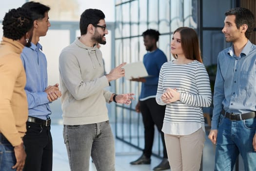 Laughing multiethnic business people talking in the office.