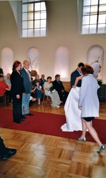 THE CZECHOSLOVAK REPUBLIC - CIRCA 1990s: Retro photo shows newlyweds and wedding guests during wedding ceremony. Vintage color photography Circa 1990.