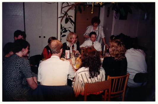 THE CZECHOSLOVAK REPUBLIC - CIRCA 1990s: Retro photo shows people at the home party. Vintage color photography. Circa 1990.