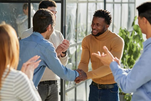 Shot of a happy businessman welcoming his new colleague to the team during a meeting in the boardroom.