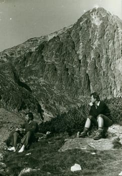 THE CZECHOSLOVAK SOCIALIST REPUBLIC - CIRCA 1970s: Retro photo shows tourists have a rest during mountain trip. Vintage photography. Circa 1970.