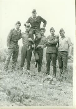 THE CZECHOSLOVAK SOCIALIST REPUBLIC - CIRCA 1970s: Retro photo shows young men - soldiers pose outdoors. Vintage photography. Circa 1970.