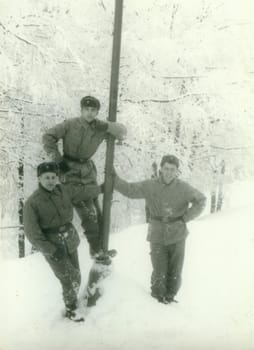 THE CZECHOSLOVAK SOCIALIST REPUBLIC - CIRCA 1970s: Retro photo shows young men soldiers during winter time. Soldiers pose outdoors snowy weather. Vintage photography. Circa 1970.